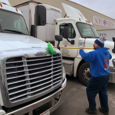 Team Johnson washing truck grille.